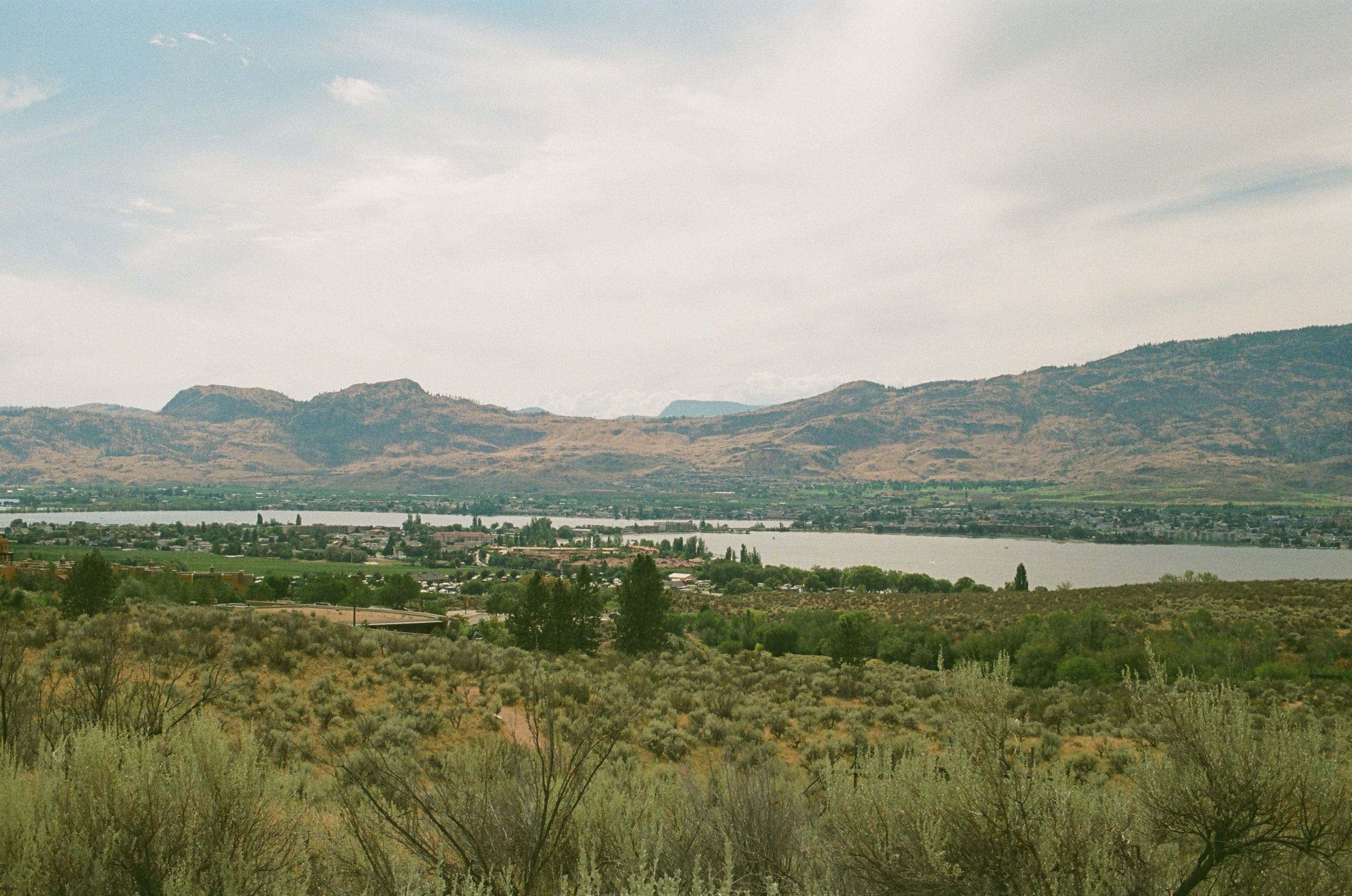 Valley of sage and grass with a lake and hills