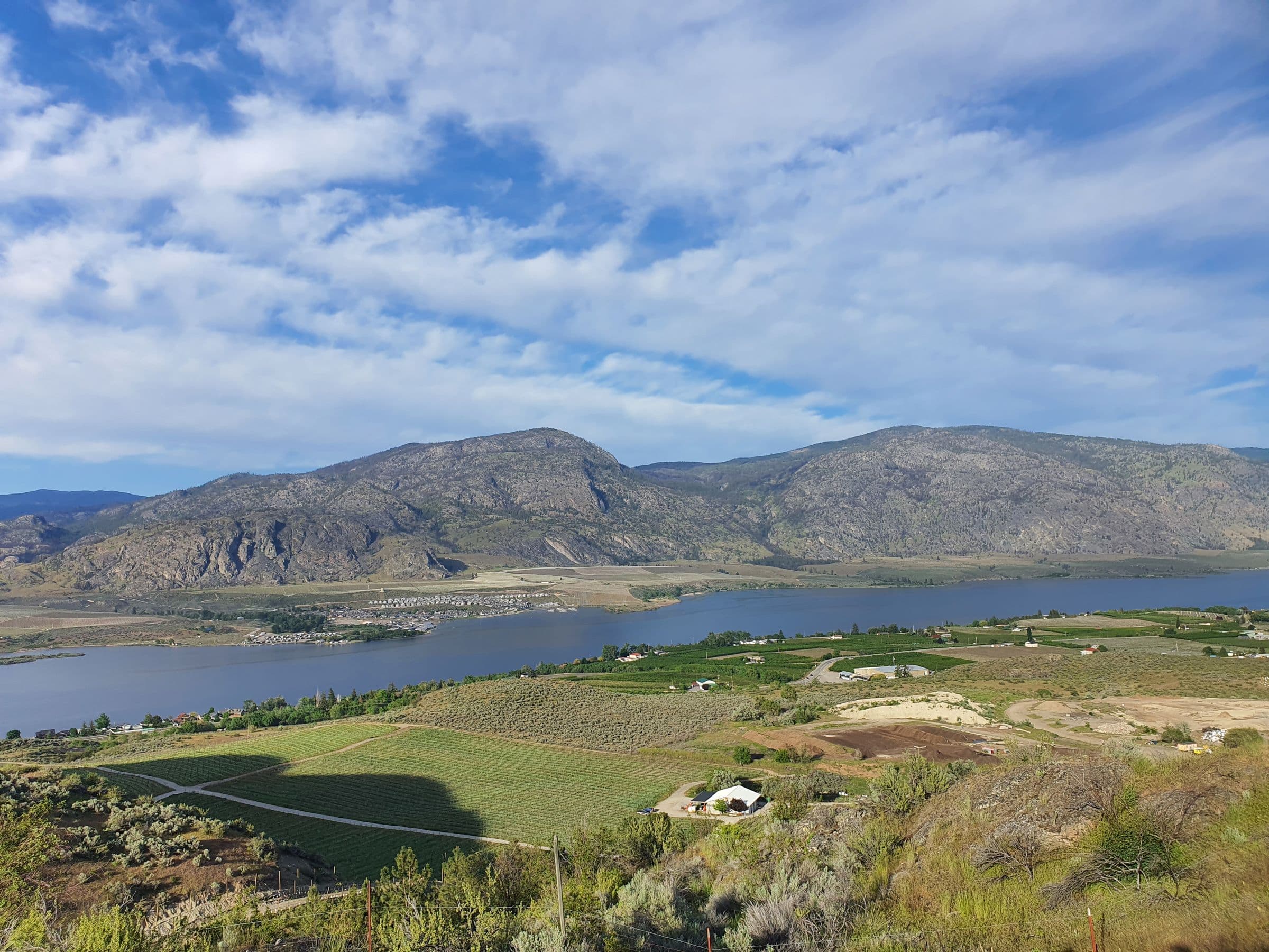 Lake and valley farmland under rolling hills